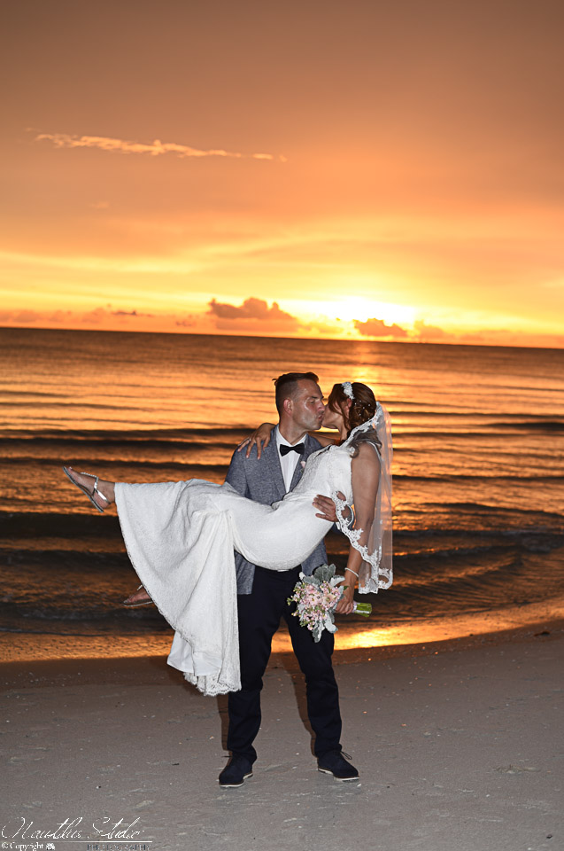 Photo taken by Events and More Inc showing couple kissing at sunset