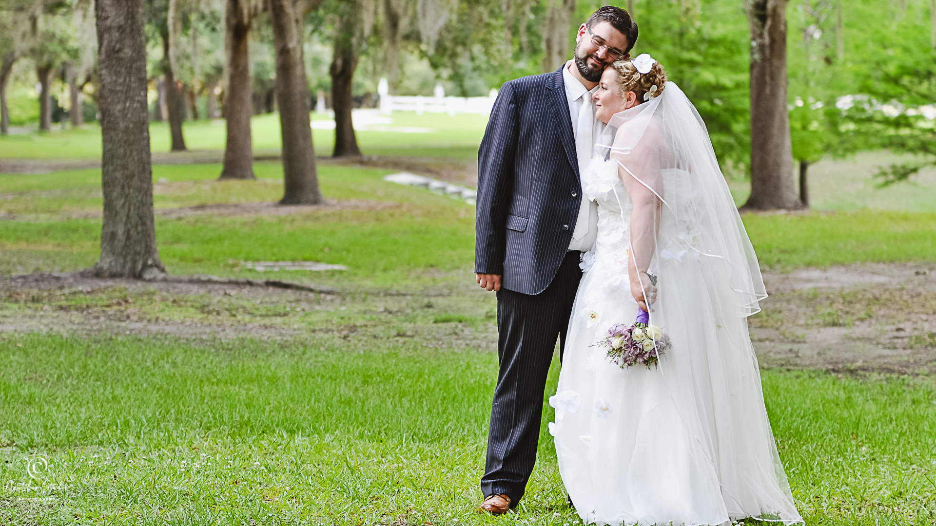 Orlando destination wedding showing couple hugging in grassy area