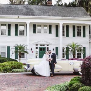 Orlando destination wedding showing bridal couple in front of Cypress Grove Estate.