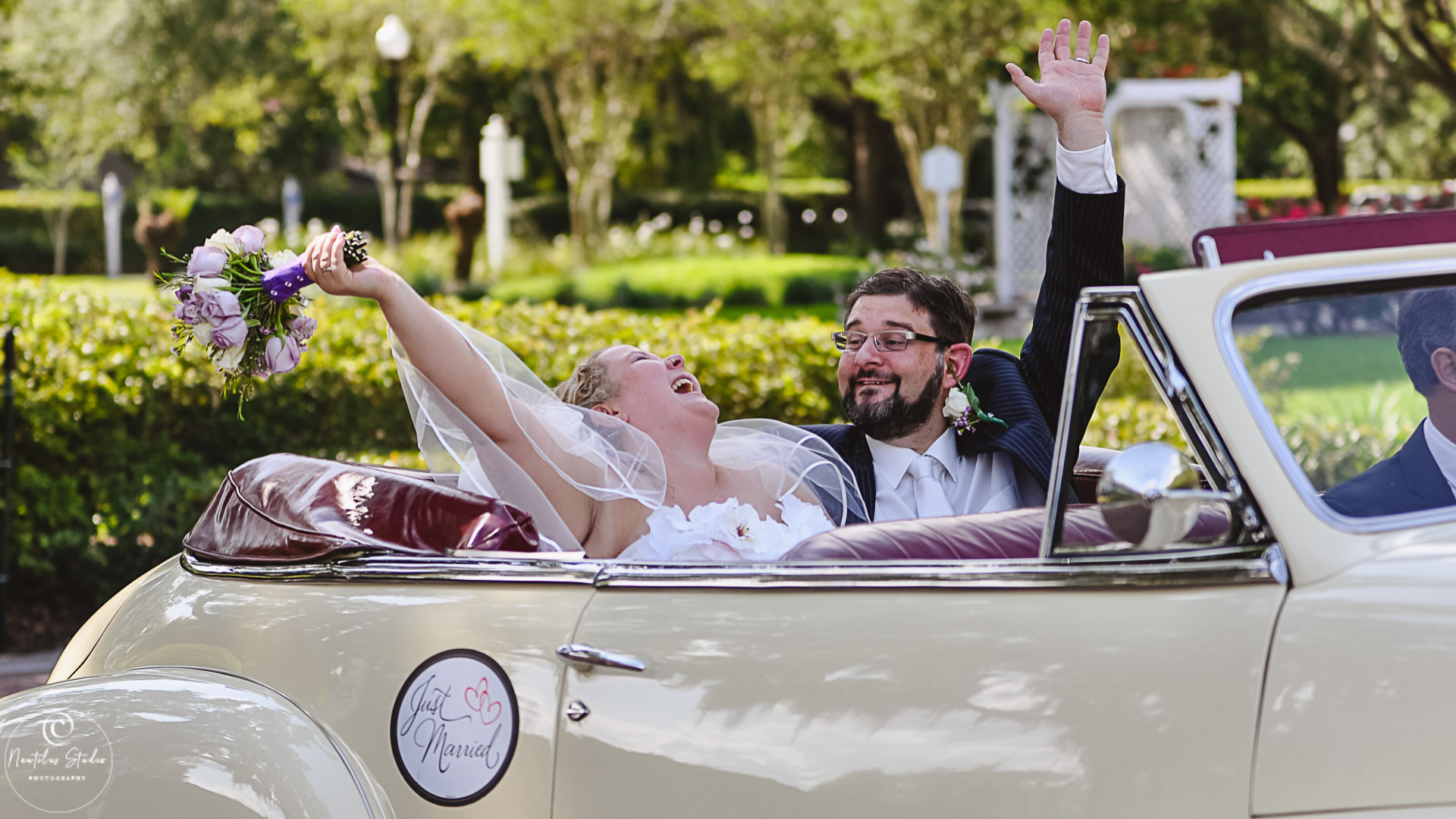 Orlando destination wedding showing couple in vintage car laughing