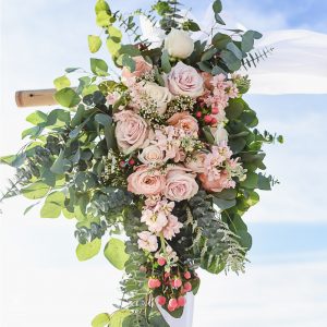 peach and creme wedding arch flower arrangement