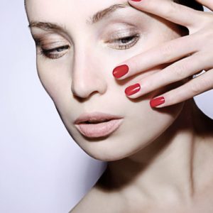 Photo showing model with red nails