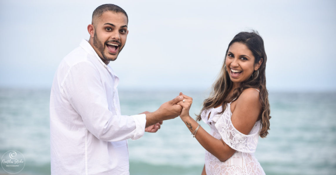 Fort Lauderdale beach proposal showing couple holding hands