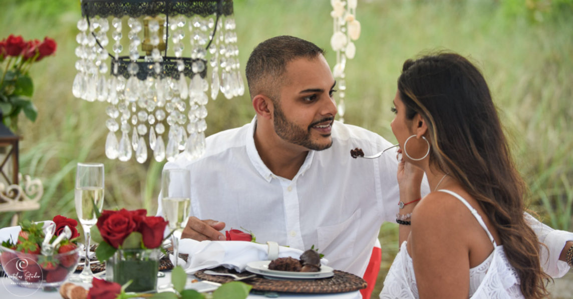 Picnic marriage proposal showing couple eating cake