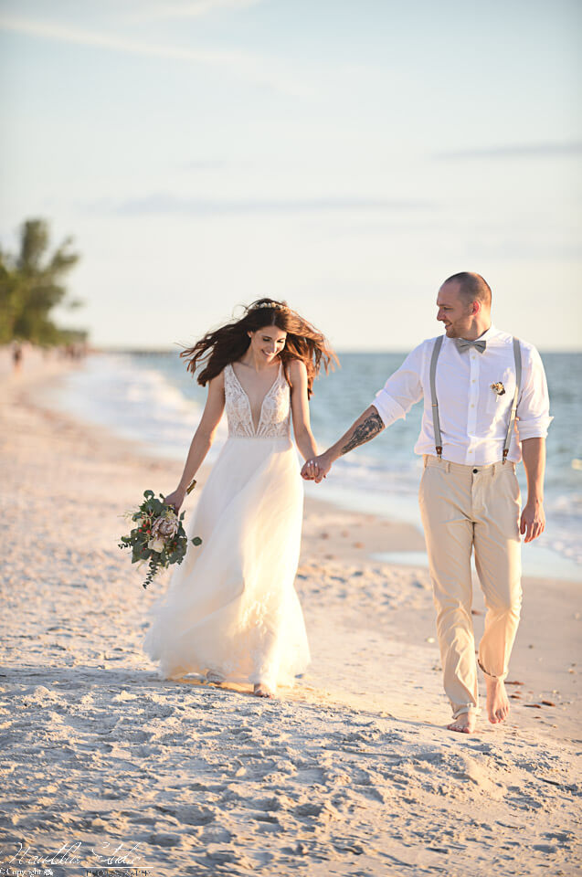 Photo of couple walking on the beach at their Florida Beach wedding in Naples