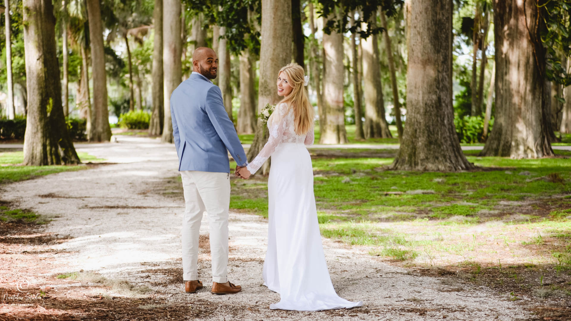 Photo of garden wedding in Florida couple walking hand in hand