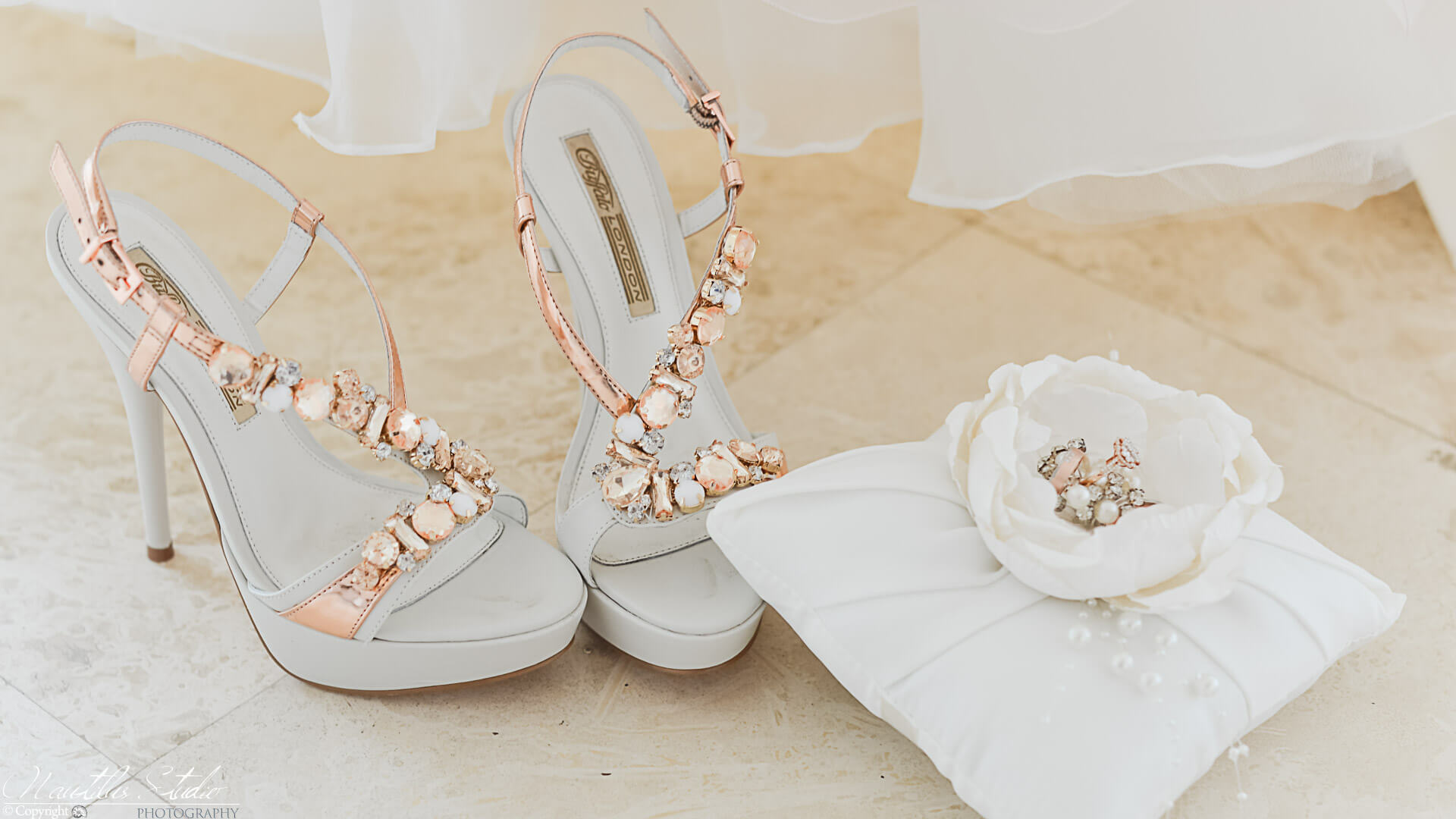 Wedding services photo of bridal shoes and ring pillow