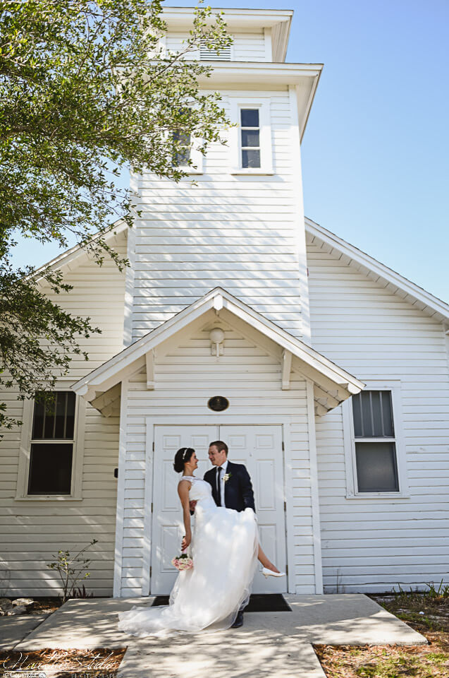 Photo of bride and groom infront of the white wedding chapel in Englewood