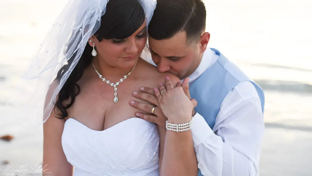 clearwater beach wedding couple Clearwater Beach Wedding photo of groom kissing brides shoulder on Clearwater Beach