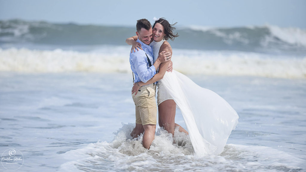Photo showing couple in Cocoa Beach that trashed the dress in the ocean