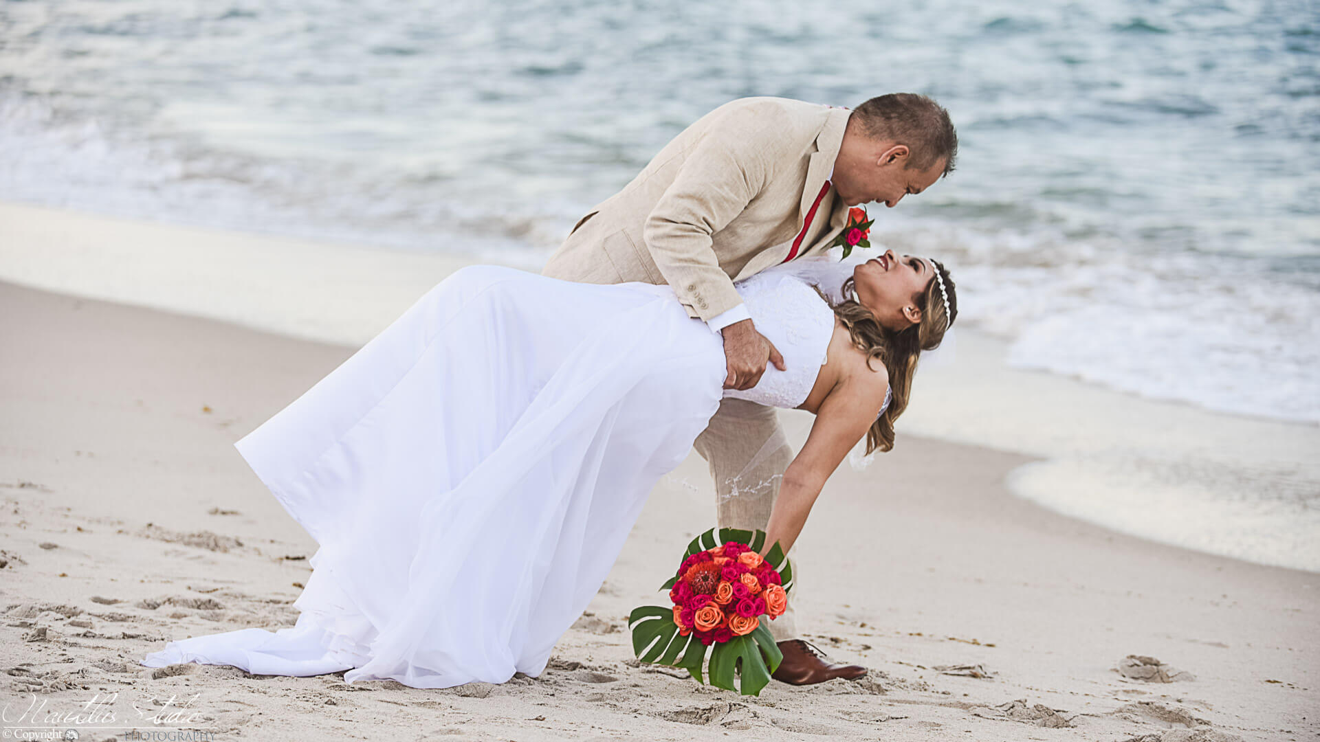 Commitment ceremony Florida, photo showing groom dancing with bride on the beach
