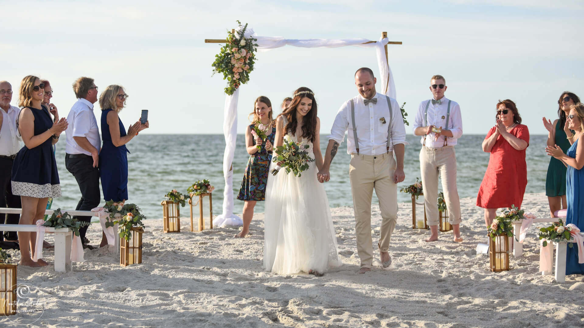 Florida beach wedding package showing couple walking down the aisle