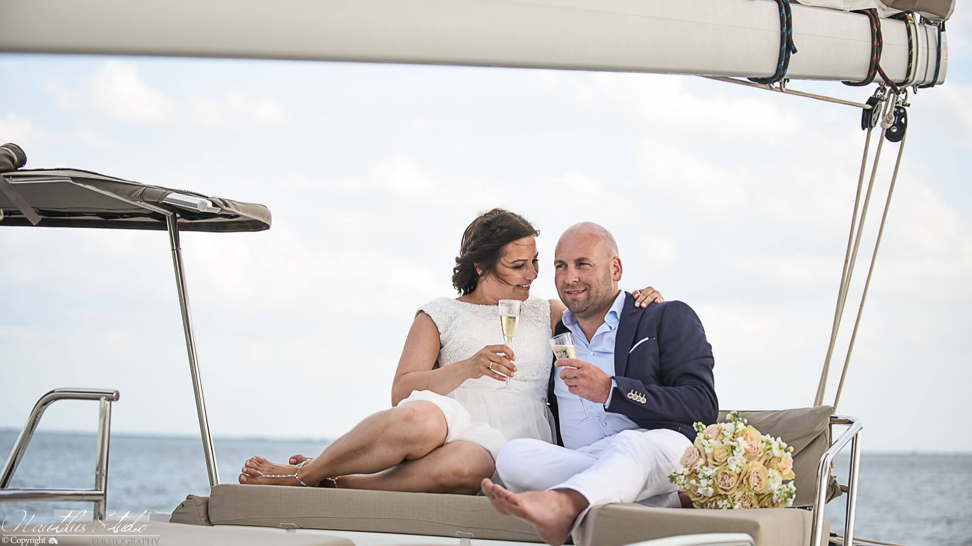 Photo of sailboat and yacht wedding wedding couple on sailboat