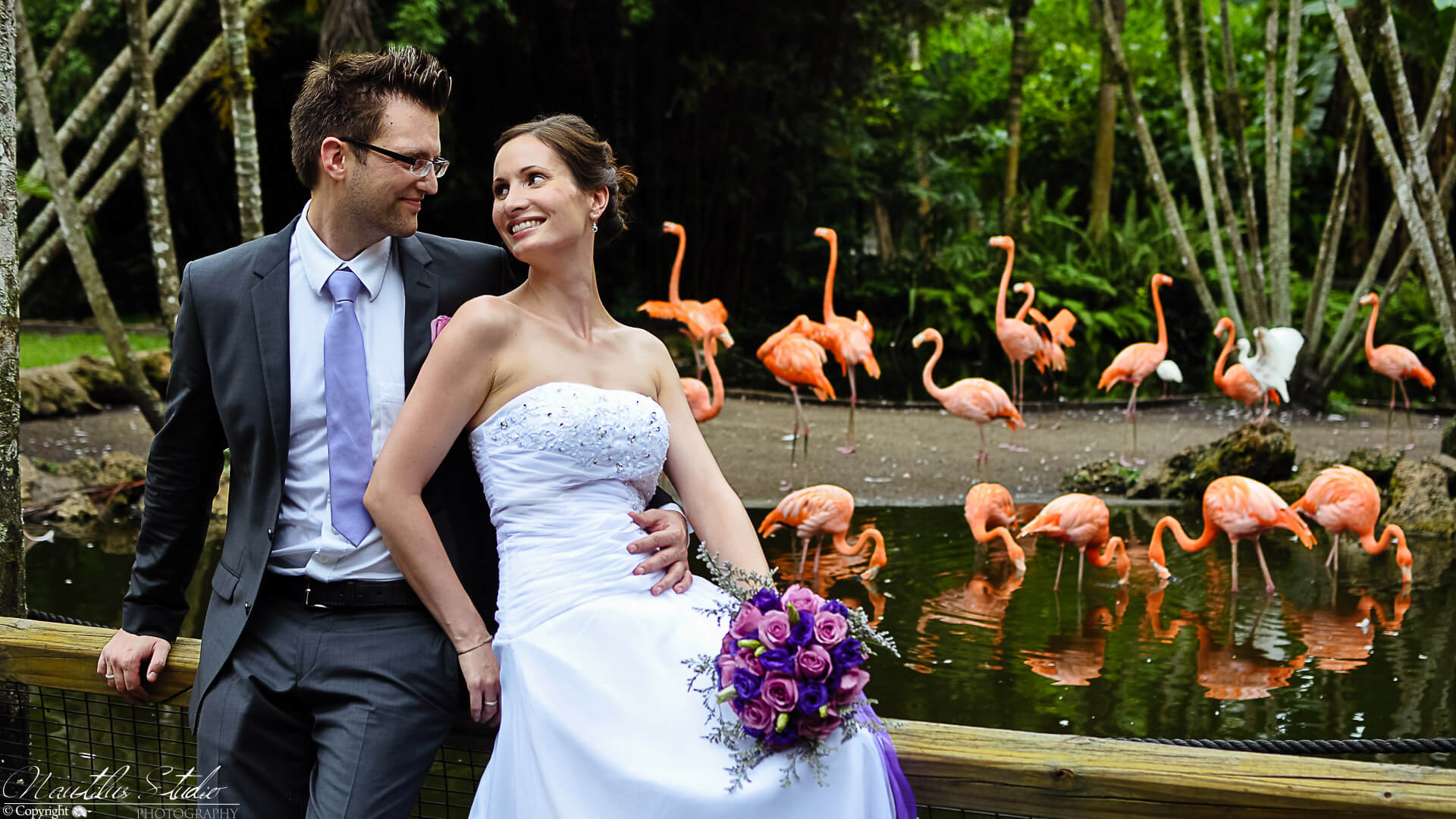 Florida garden wedding photo of bride and groom with flamingos