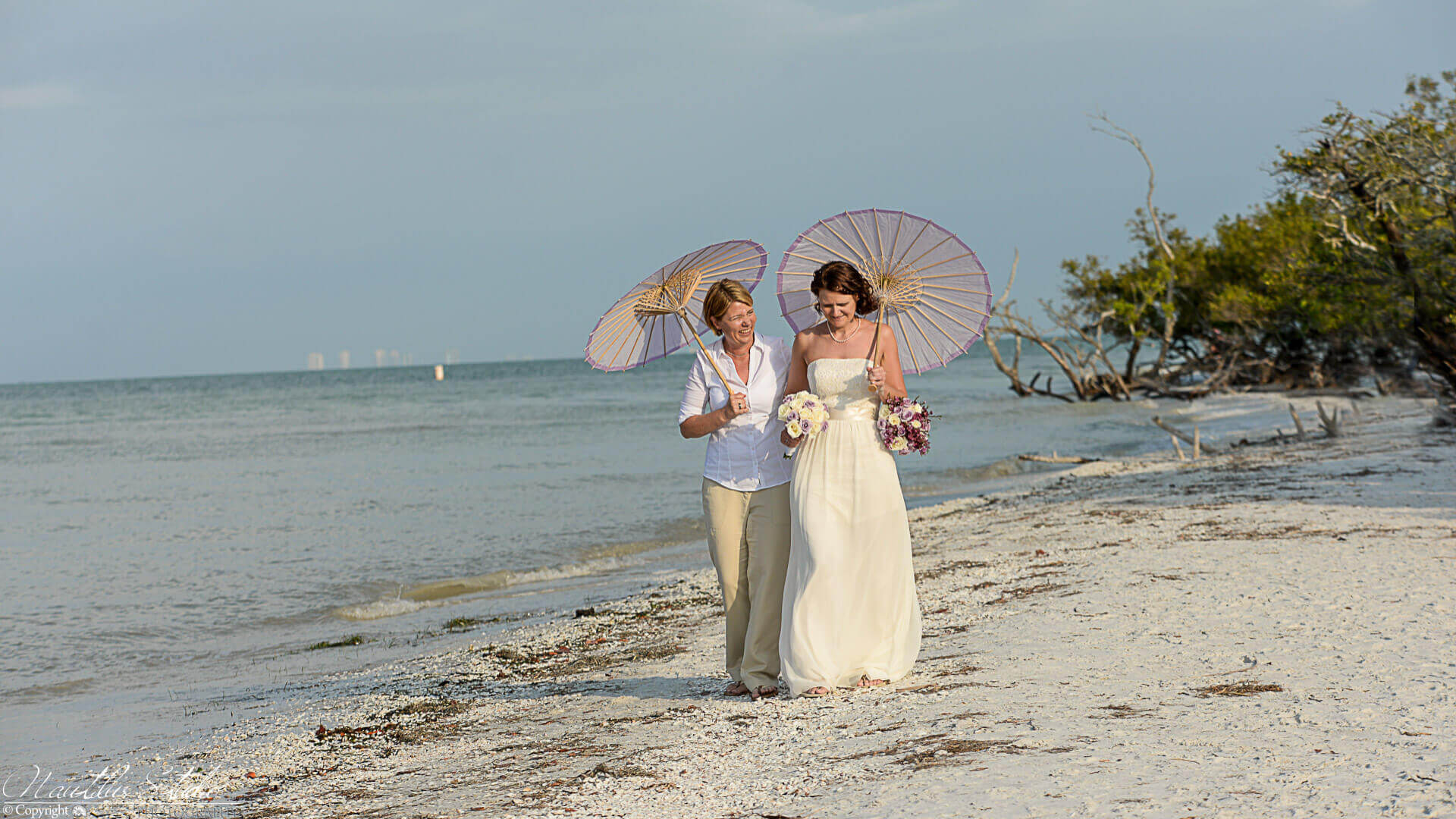 Photo of gay wedding in Sanibel Island showing two women with parasols
