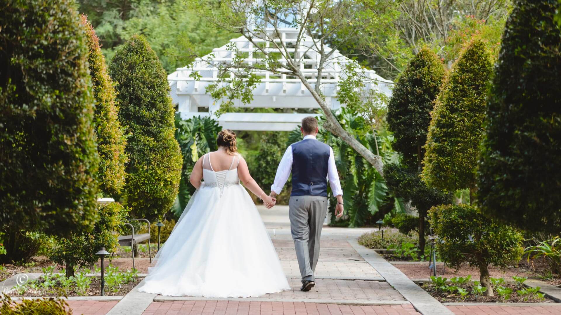 Florida garden wedding photo bride and groom walking in Leu Gardens Orlando