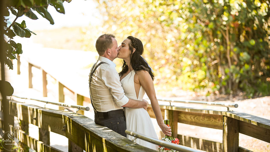 Longboat Key wedding showing couple kissing on boardwalk