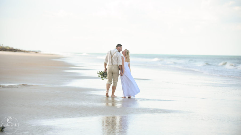 Photo of wedding couple walking on the beach in Palm Coast Florida