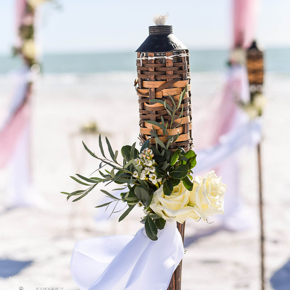 Florida beach wedding package showing decorated tiki torches