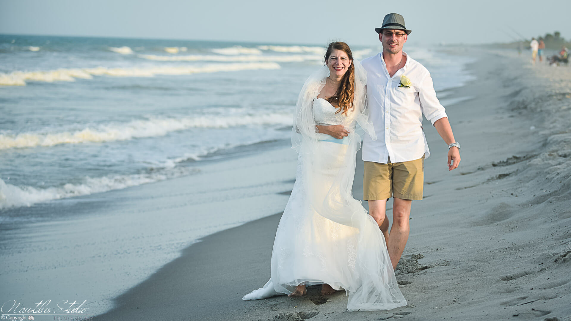 Photo showing vow renewal couple on Cocoa Beach walking