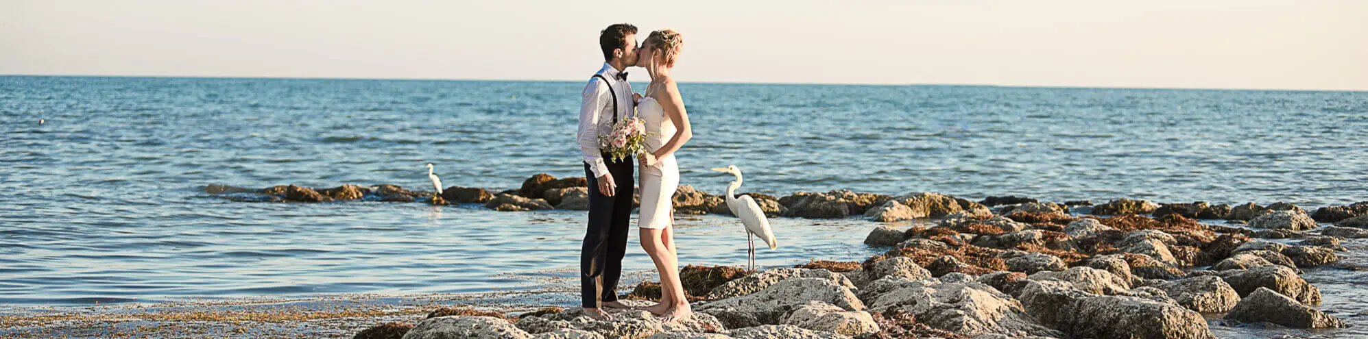 wedding in florida portfolio header Florida marriage license by mail information couple standing on rocks