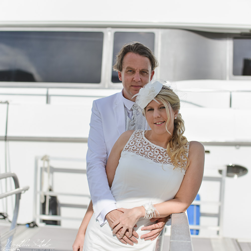 Photo of wedding couple in front of their luxury yacht at their Florida yacht wedding