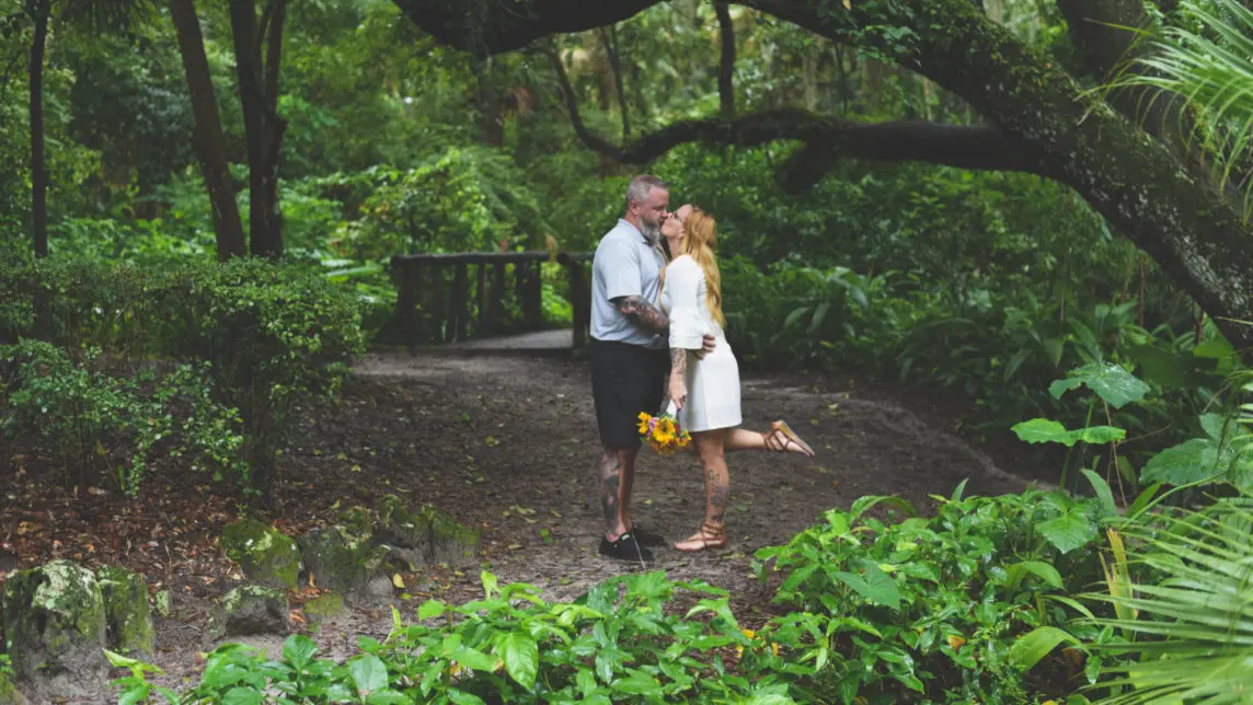 Wedding package Marion County Florida bride and groom kissing under oak tree