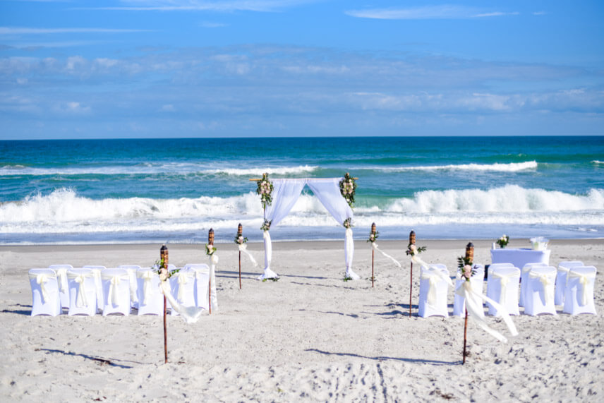 Photo of lifestyle wedding in Cocoa Beach Florida, wedding arch with fresh flowers