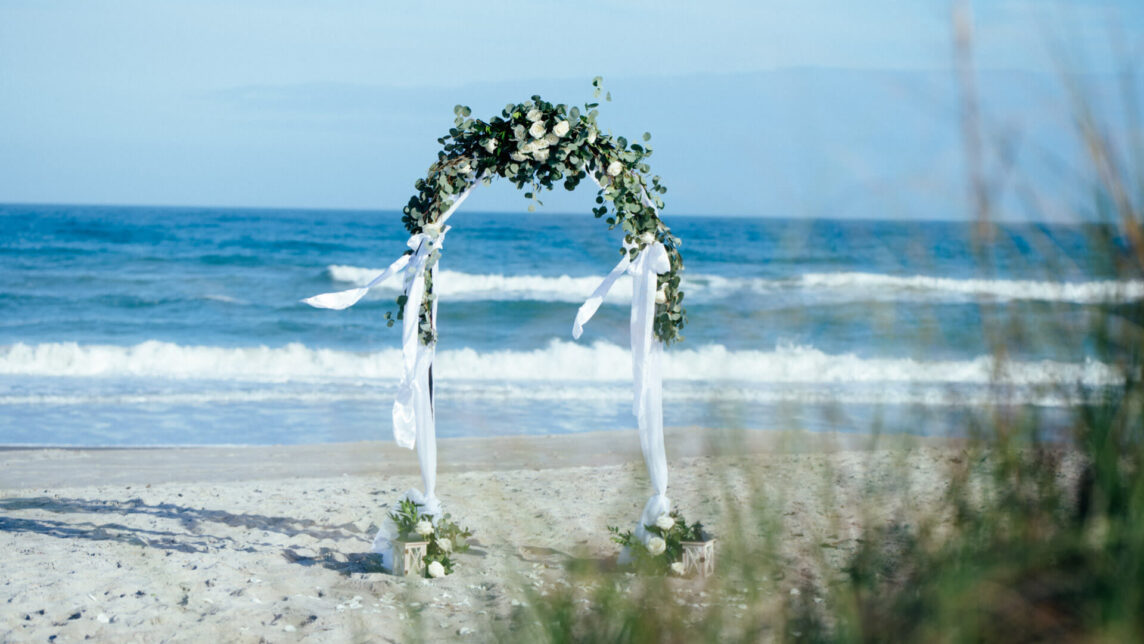 Beach wedding package for 2 Florida, photo showing round wedding arch with fresh flowers in Cocoa Beach