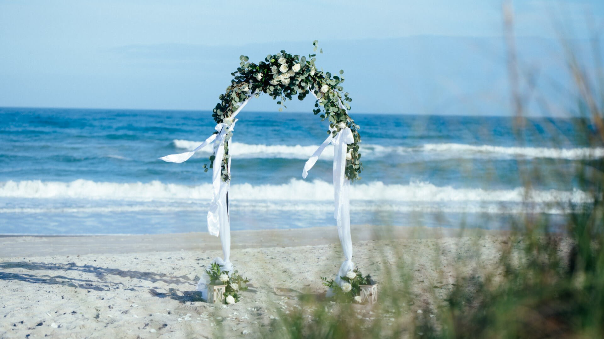 Beach wedding package for 2 Florida, photo showing round wedding arch with fresh flowers in Cocoa Beach