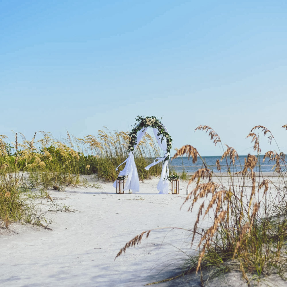 Beach wedding package in Florida, photo showing round wedding arch with fresh flowers