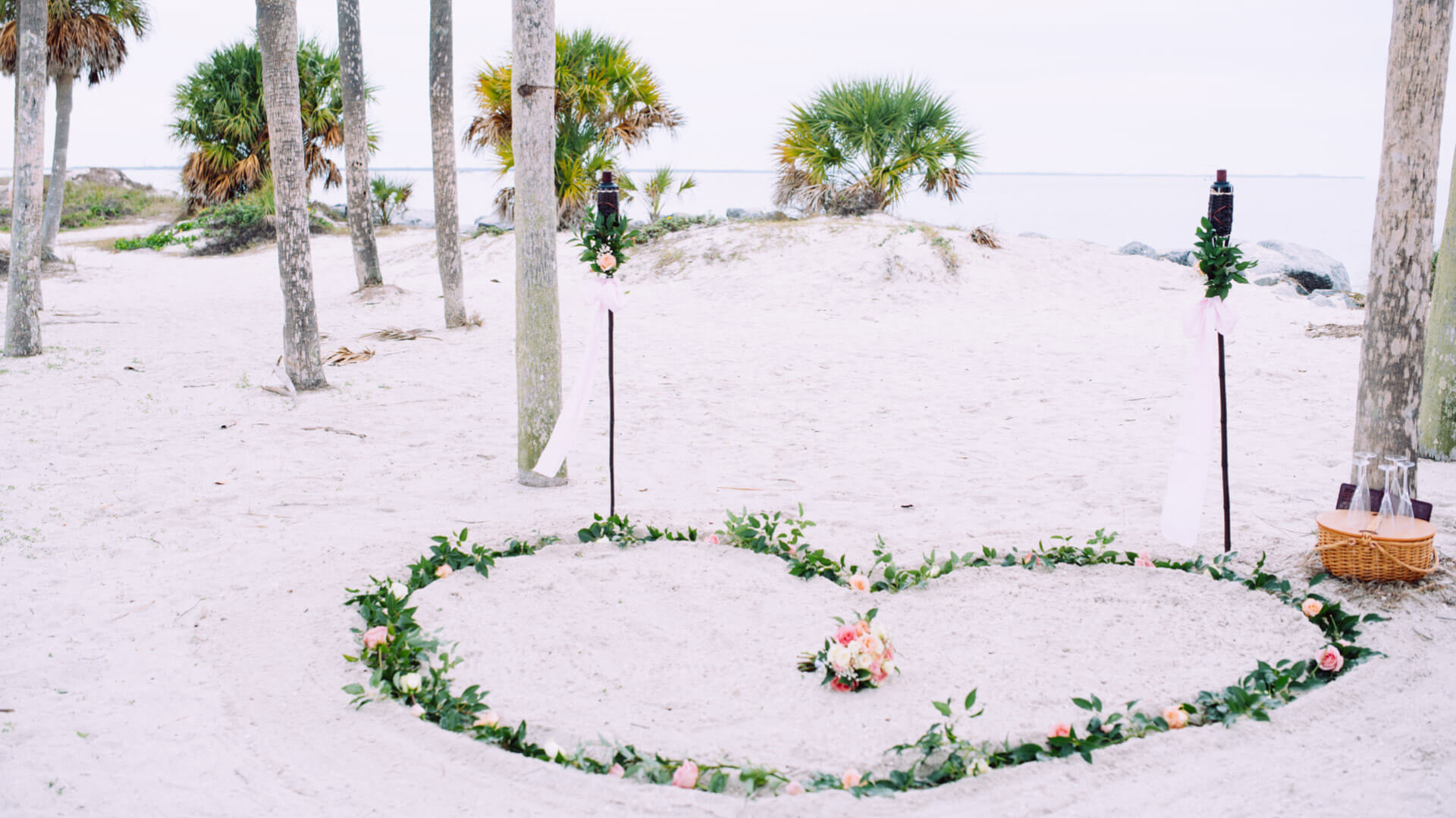 Simplicity minimalist elopement wedding package, photo showing heart in the sand with fresh flowers at Fred Howard Park wedding in Tarpon Springs