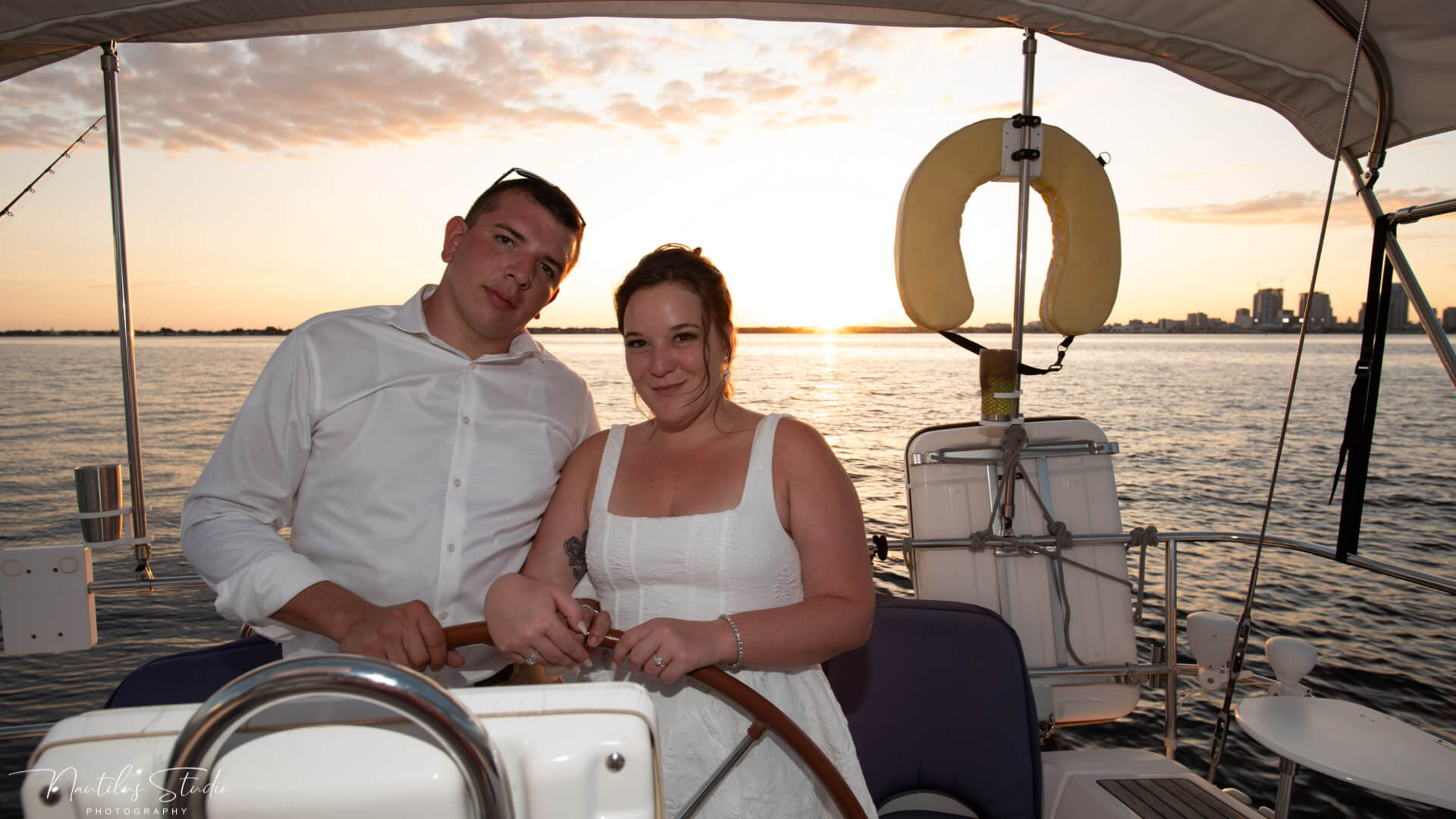 Photo showing bride and groom sailing with the sunset behind them in Tampa Bay