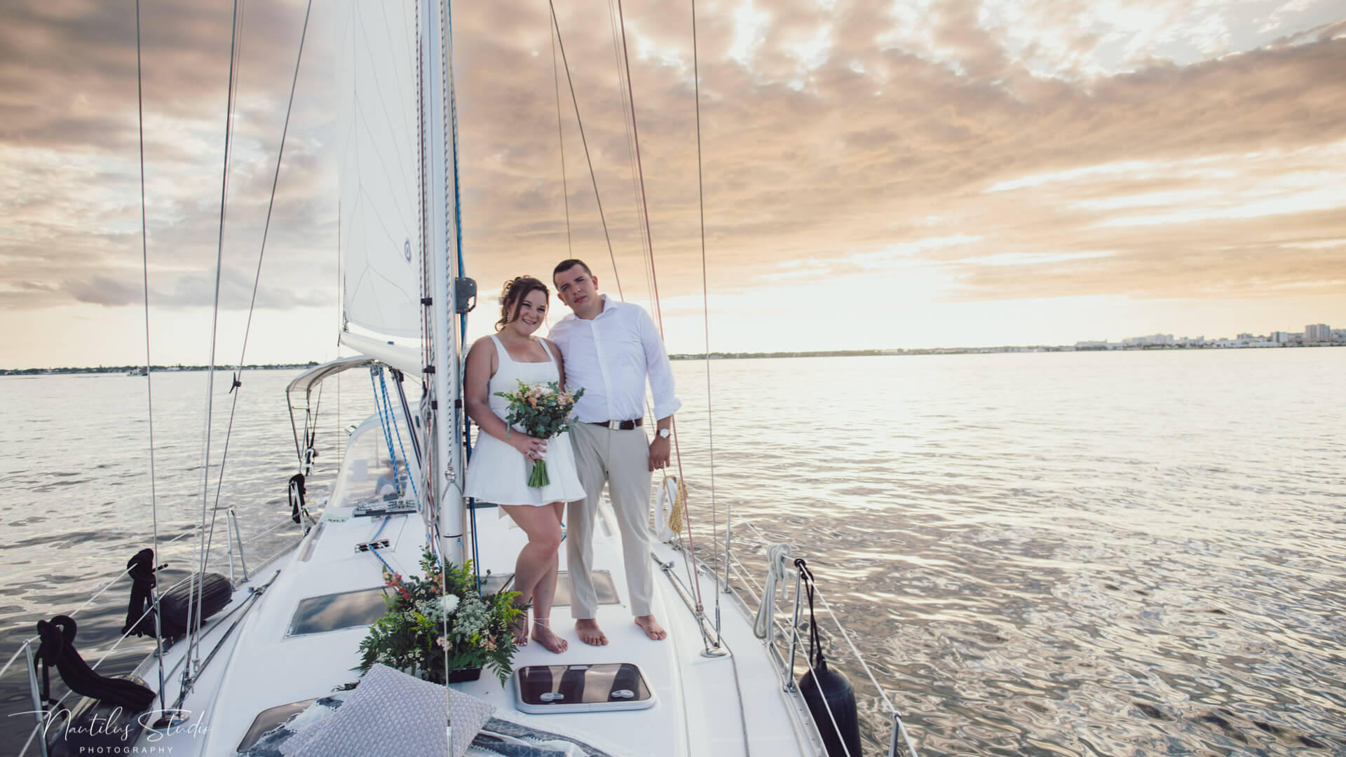 Exclusive sailboat elopement showing the wedding couple riding in the sunset in St. Petersburg