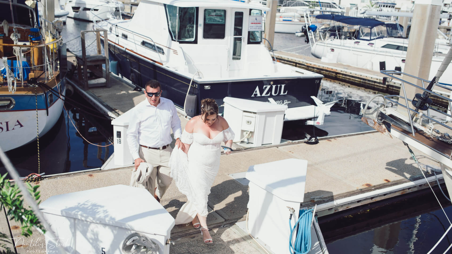 Photo of bride and groom arriving at the harbor for their sailboat wedding in St. Petersburg