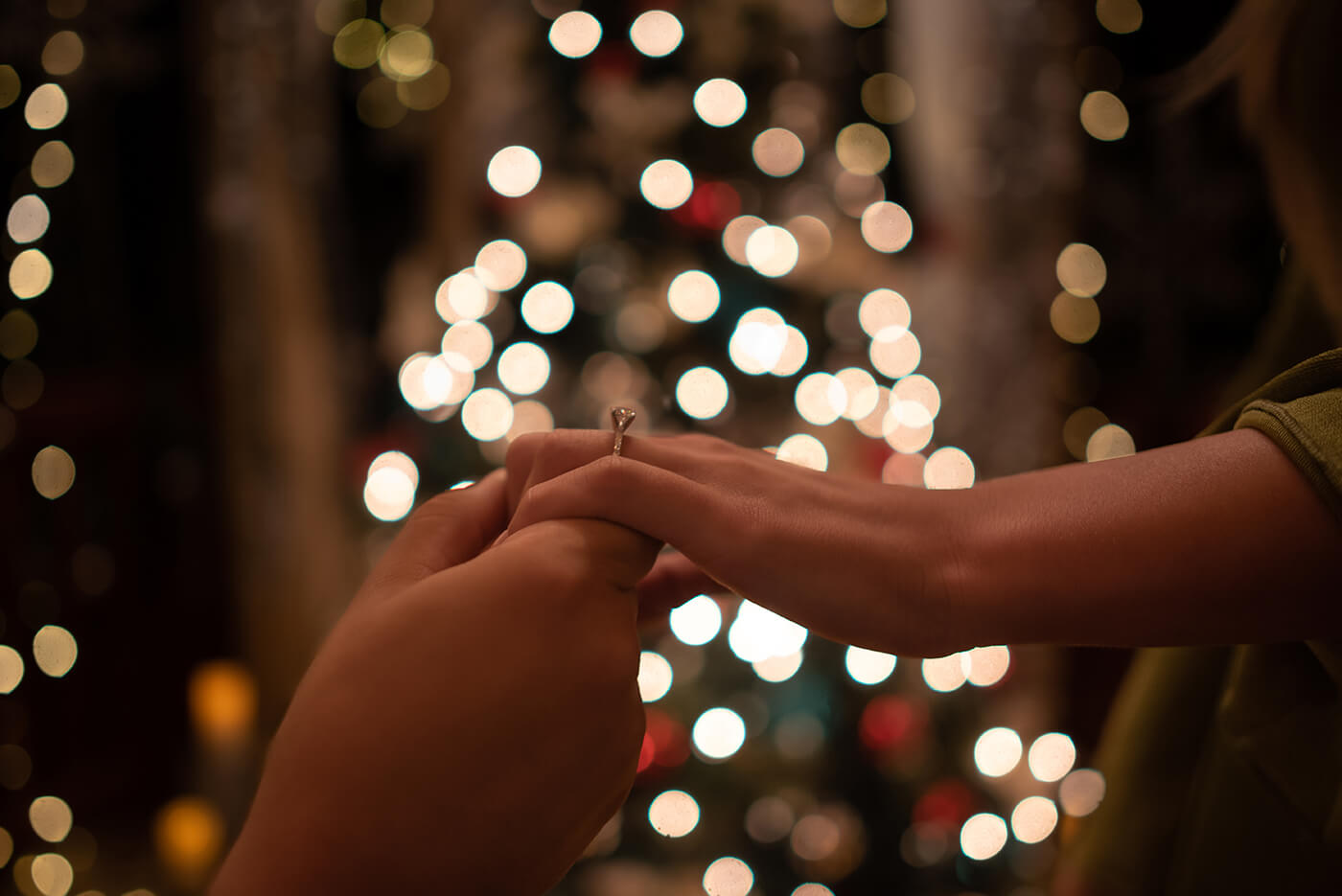 Photo of hands of newly engaged showing the ring at Dazzling Nights Proposal in Harry P Leu Gardens Orlando